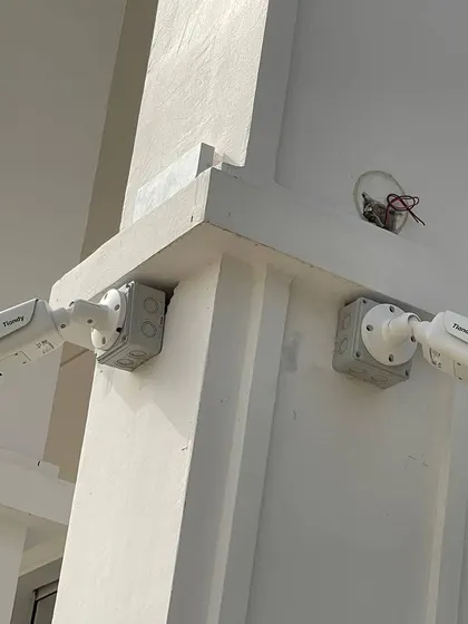 Two Tiandy bullet cameras installed on a pillar. Using weatherproof junction boxes protects the connections from rain and dust.