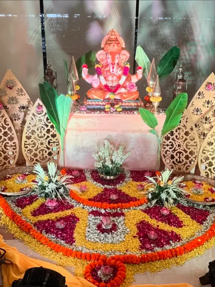 An intricate floral rangoli and Ganesha setup for a puja at Holiday Inn. We used petals of various flowers to create a detailed pattern around the idol, complemented by modern laser-cut panels.