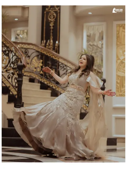 A candid shot of the bride's sister, Lekha, in a moment of pure happiness and movement on the grand staircase.