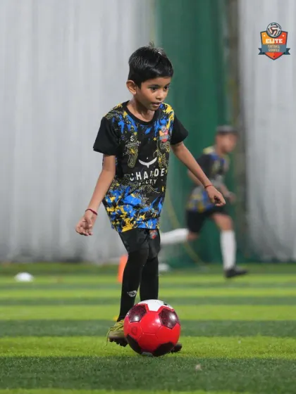 A player works on his ball control with a red ball, a drill designed to improve touch and precision.