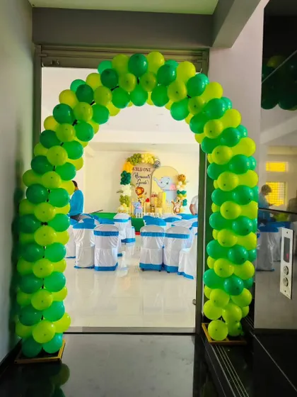 A simple yet effective balloon arch in bright green makes for a perfect entrance to a jungle-themed party, setting the mood right from the start.