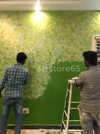 Our team collaborating on a large green and yellow textured wall. We work together to ensure a consistent and beautiful finish across the entire surface.