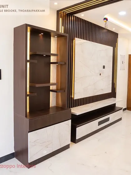 A standalone pooja unit at Jain's Pebble Brooke, designed with clean lines, internal lighting, and a mix of wood and marble-finish laminates.