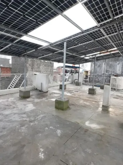 A view from underneath the 13.5 kW solar panel structure at our Sangam Vihar project. The high-quality, galvanized iron framework is built to last, providing a secure foundation that protects both the panels and your roof.