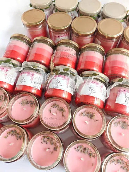Pink ombre layered jar candles with lavender bud toppings, created as return gifts for a 25th wedding anniversary.