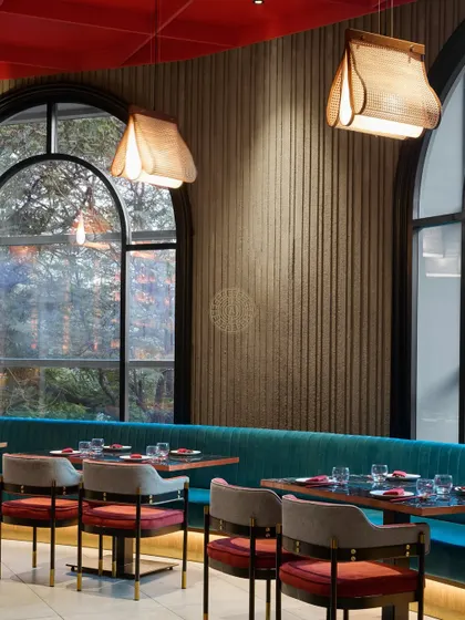 A close-up of the fluted wall texture and custom lighting, details that add warmth and sophistication to the dining experience.