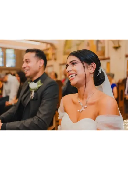 A beautiful candid moment of the bride laughing with joy during her wedding ceremony.