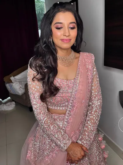 The full Sangeet look, showing the detailed pink lehenga and the soft, romantic makeup.