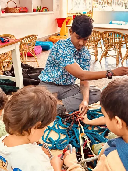 A group of young learners practice tying knots with our guest expert. We believe in bringing in people from the community to share their passions and expertise, enriching our curriculum in countless ways.