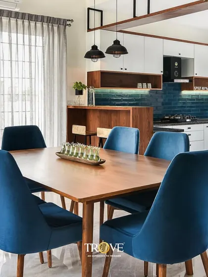 Here is how my tiles can bring a space together. This open-plan dining and kitchen area features a deep blue subway tile backsplash that adds a pop of color and texture, creating a sophisticated yet welcoming atmosphere for family meals.
