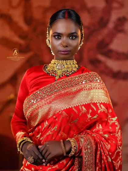 This portrait captures the strength and grace of a South Indian bridal look. I used dramatic lighting to accentuate the rich red of the saree and the intricate gold jewelry, creating a powerful image that’s perfect for a professional portfolio.
