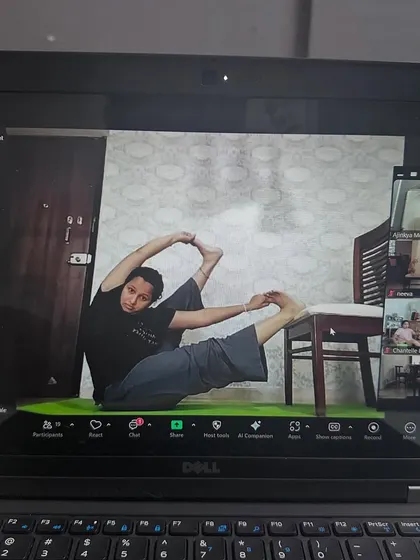 Focus and dedication in our 5pm online class. This student is using a chair to assist her in a challenging seated hip-opening posture.