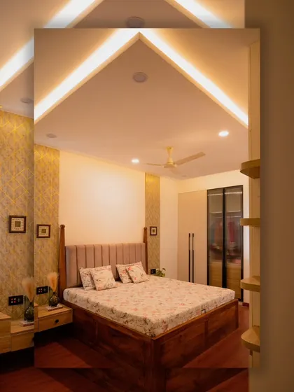 The vaulted ceiling in this bedroom is accentuated with profile lighting, creating a sense of height and spaciousness while providing soft, indirect light.