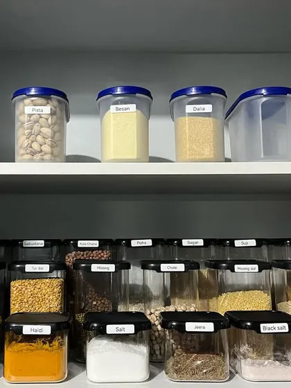 This lower cabinet transformation shows how we maximize space. By using matching containers for spices and pulses and labeling everything, we created a system that is both beautiful and highly functional.