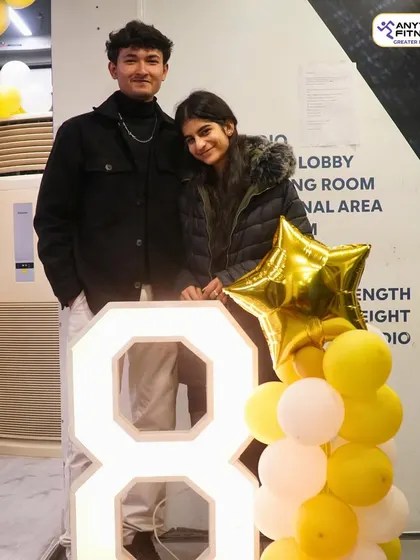 A couple of our members posing during our 8th-anniversary party. It's a celebration of the community we've built together over the years.