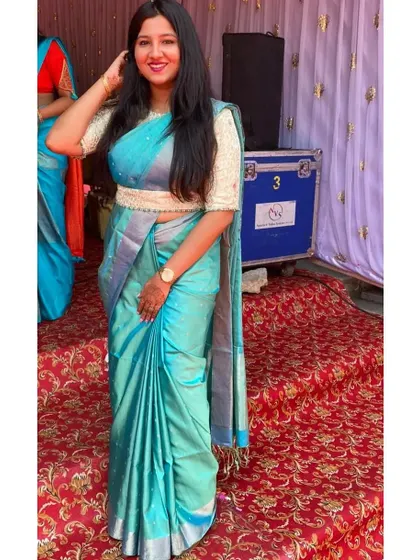 A full view of the client in her elegant brocade blouse and saree combination, a perfect look for attending a wedding.