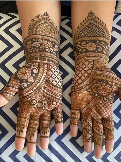 A very neat and elegant design for the hands. This pattern uses a combination of floral bands and geometric grids to create a sophisticated and traditional look.