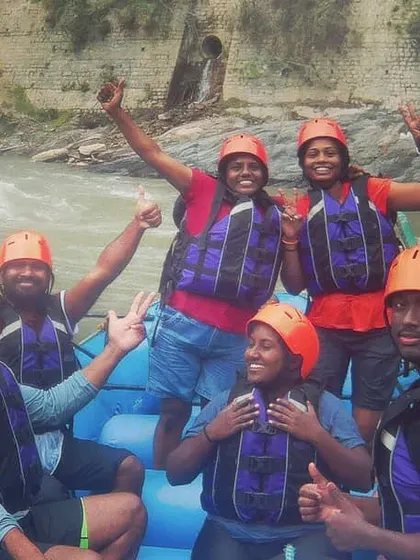 The whole crew, grinning after a thrilling 9km river rafting trip on the Beas river in Manali. When the weather closes in for one plan, we always have another adventure ready.