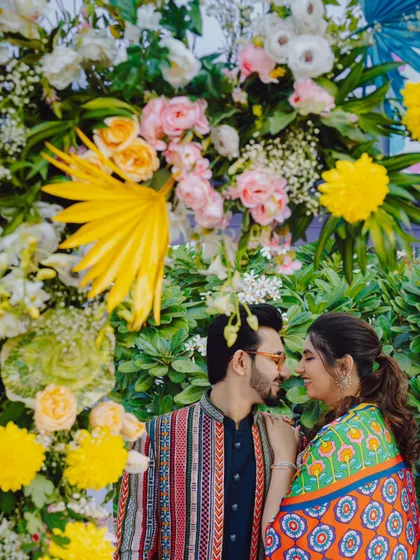 A romantic portrait of the couple amidst the vibrant floral decor of their Mehendi carnival. We always take time to get beautiful couple shots during every event.