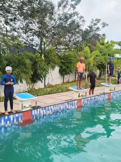 Students on the starting blocks, ready to dive in for their race. Swimming is a key part of our curriculum, fostering fitness and camaraderie.