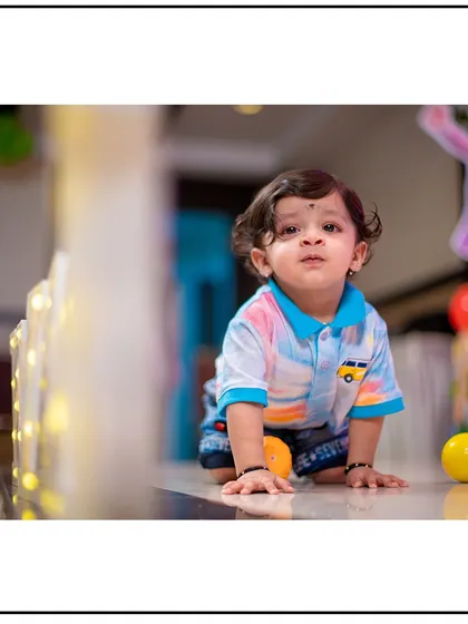An indoor shot with great lighting that feels as natural as the outdoors. This little one is captured mid-crawl, a milestone worth remembering.