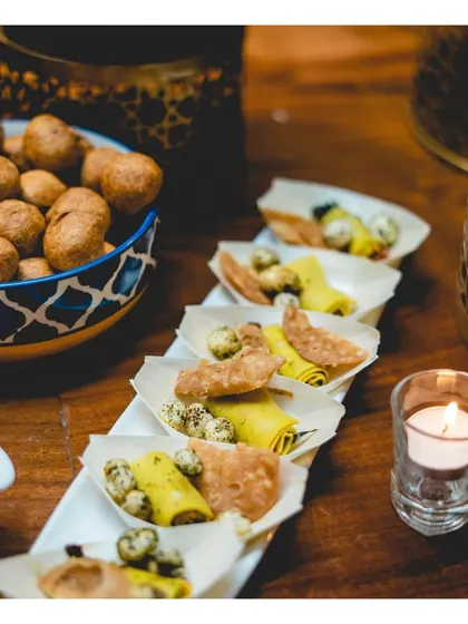Individually portioned Indian appetizers, elegantly arranged on a long platter for easy pass-around service.