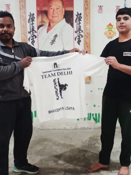 Bhavishya Lohiya gets his team t-shirt. It's a proud moment for these young karatekas.
