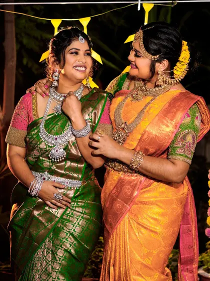 I have something for the whole bride tribe. Here you can see a bride in a traditional gold-finish set and her bridesmaid in a gorgeous American Diamond set, showing how you can coordinate styles for the whole wedding party.