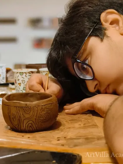 A young participant gets up close to inspect his work, showing intense concentration. We love seeing this level of engagement from our students.