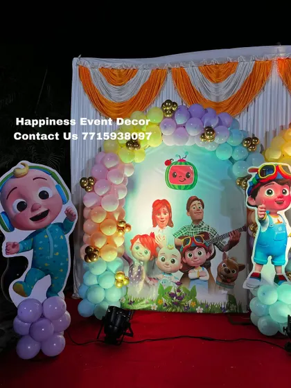 This Cocomelon theme setup is perfect for stage decorations. It includes a pastel balloon arch, a large backdrop, and cutouts of JJ and his friends.