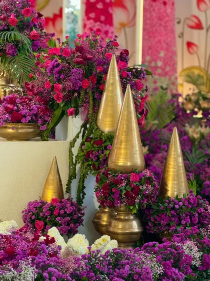 A close-up of the traditional golden decor pieces, nestled amongst a bed of vibrant purple and magenta flowers.