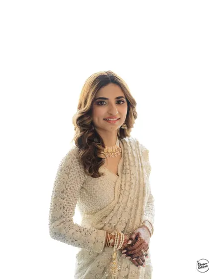 A clean, high-key portrait of the bride in her white Nikaah saree, creating a bright and angelic look.