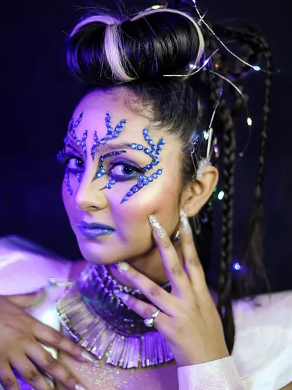 A close-up of the crystal face art. You will learn how to apply gems and other 3D elements securely and artistically.