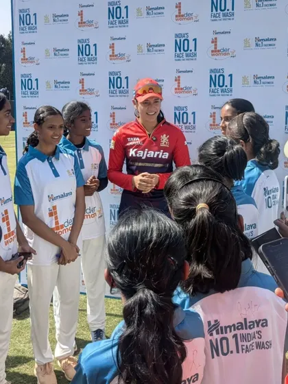 Learning from the best. Our girls' cricket team listens intently as international star Ellyse Perry shares her experiences and advice.