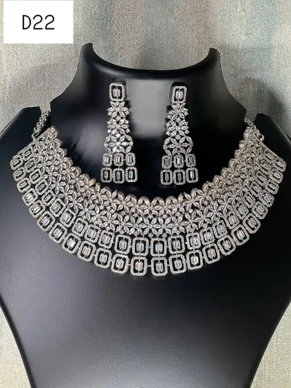 A clear, still photo of the silver American diamond choker set. The matching earrings complete this elegant set, making it a reliable choice for your next event.