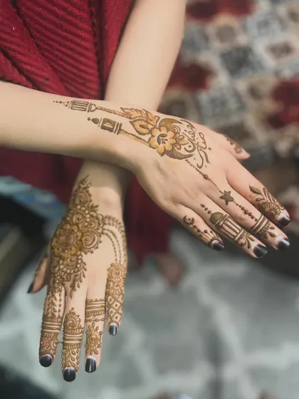 A two-hand view showing a Ramadan-themed design on one hand and a traditional floral pattern on the other.