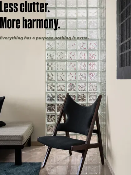 Less clutter, more harmony. This corner embodies our design principle that everything should have a purpose. The minimalist daybed and sculptural chair are perfectly balanced by the texture of the glass block wall.
