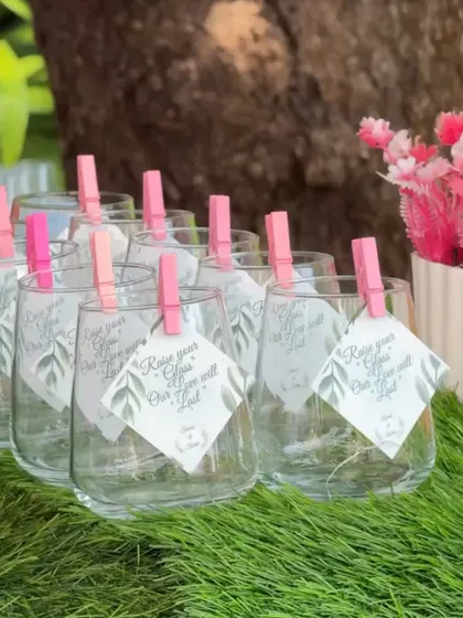 "Raise your glass, our love will last." Tiny personalized notes clipped to wine glasses are a sweet and simple detail that adds a layer of thoughtfulness to the celebration.