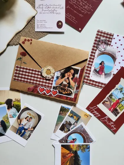 A beautifully arranged birthday hamper, with a custom envelope, photo cards, and other small keepsakes.