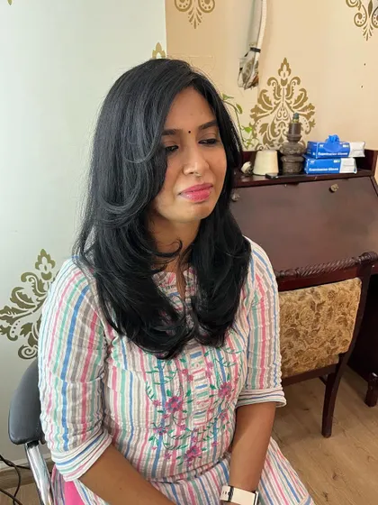 Feathered hair and side-swept bangs for Ramya.