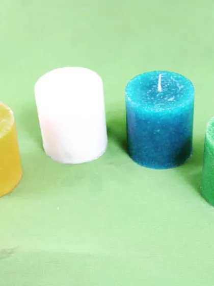 A simple photo showing some of the color variety in my small pillar candles: yellow, white, blue, and green. This is a sample of what I can provide for wholesale orders.