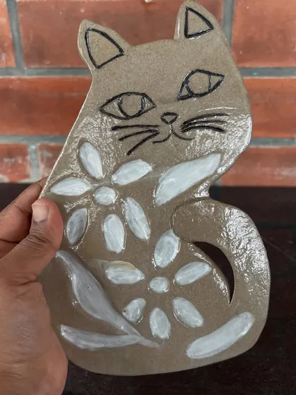 A whimsical cat-shaped spoon rest, hand-built and painted by a young artist in my 15-day beginner course.