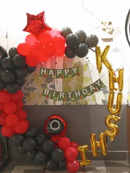 For fans of the hit show, we offer a 'Squid Game' theme decoration. This setup uses the iconic red and black color scheme with character balloons and a custom birthday banner.