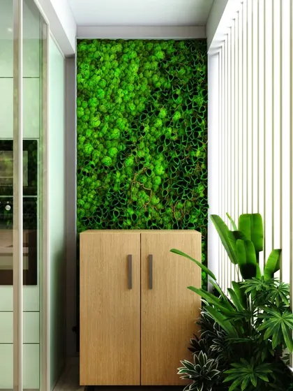 A preserved moss wall is a unique and maintenance-free way to bring a vibrant touch of green into your home, as seen in this balcony design.