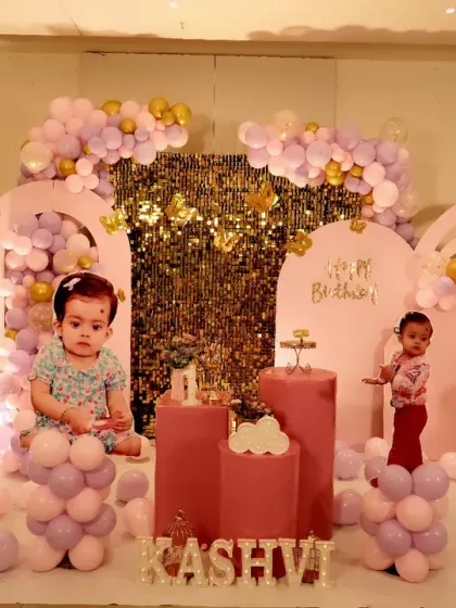 A magical butterfly garden was the theme for Kashvi's first birthday celebration. We used soft pastel pink and lavender balloons, large custom butterfly wing cutouts, and a shimmering gold sequin backdrop to create this enchanting and delicate setting for the little princess.