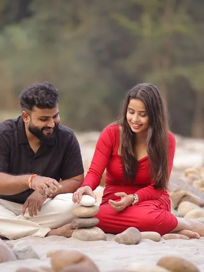 A quiet moment shared between the couple during their pre-wedding shoot. Sitting among the river stones in Rishikesh, this shot feels intimate and peaceful, a perfect memory before their big day.