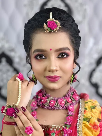 The model showcasing her floral hand jewellery, a key part of the Haldi look.