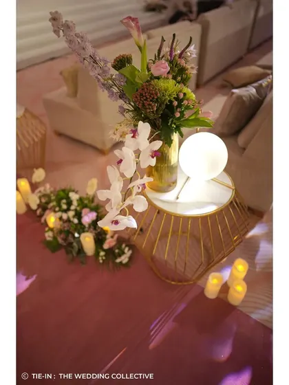 Even the smallest details were thoughtfully designed, like this side table arrangement featuring a modern globe light, fresh orchids, and candles. It's these curated touches that elevate the overall guest experience.