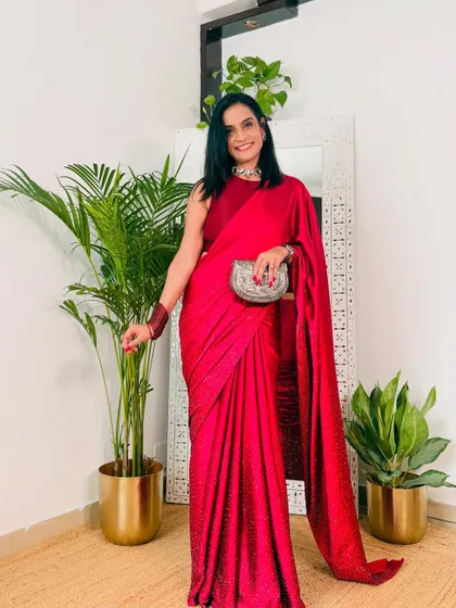 A bold and beautiful red satin saree. This is a classic choice for any celebration, be it Karva Chauth, a wedding, or a festive party. The satin gives it a luxurious feel.