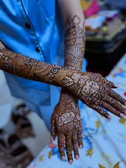 This bridal design for a beautiful air hostess includes the names "Ayesha" and "Moin" hidden within the clouds, a creative nod to her profession.
